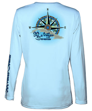 Ladies Cuban t-shirt | back view of a light blue long sleeve performance v-neck t-shirt depicting a blue green compass rose artwork and outline of the island of Cuba
