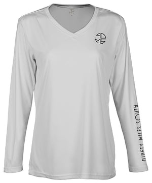 front view of a ladies light silver v-neck performance shirt with 90 Miles South Round left chest logo and right sleeve copy saying “90 Miles South”